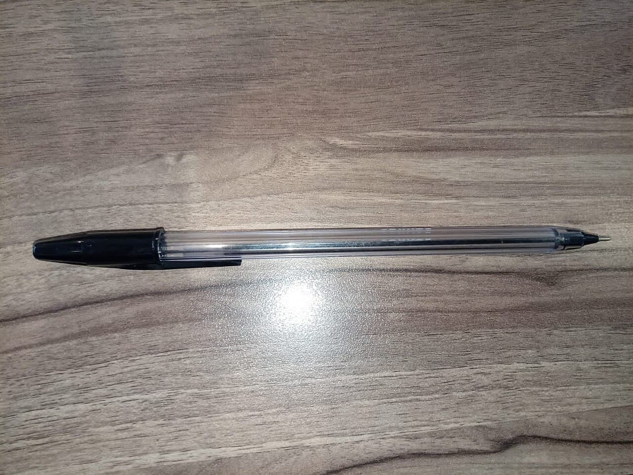 Black drafting pen on a wooden surface